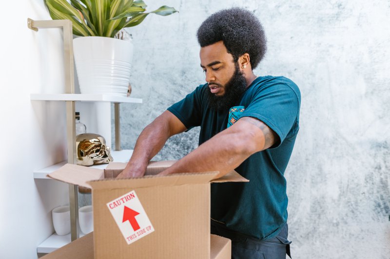 This photo shows a professional mover carefully packing office assets