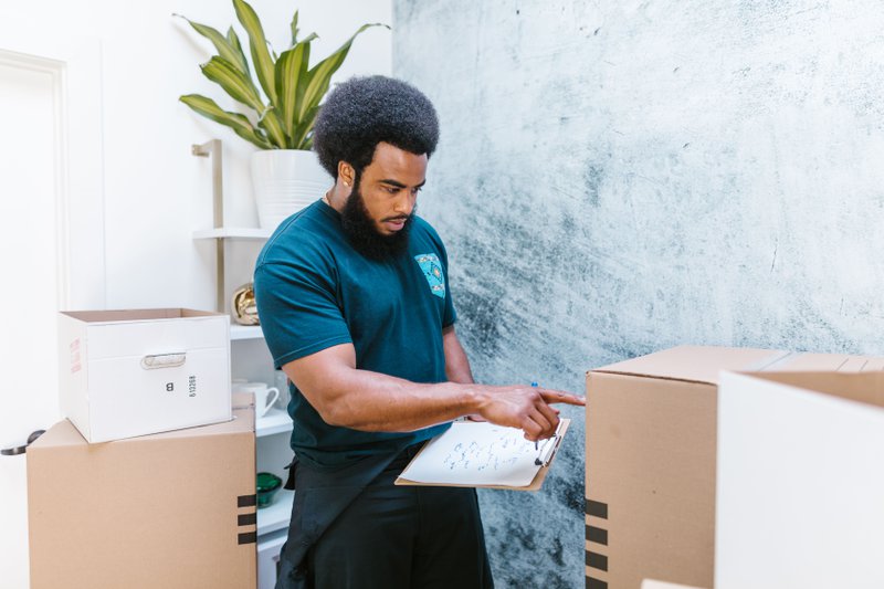 This photo features a professional office relocation services provider doing inventory
