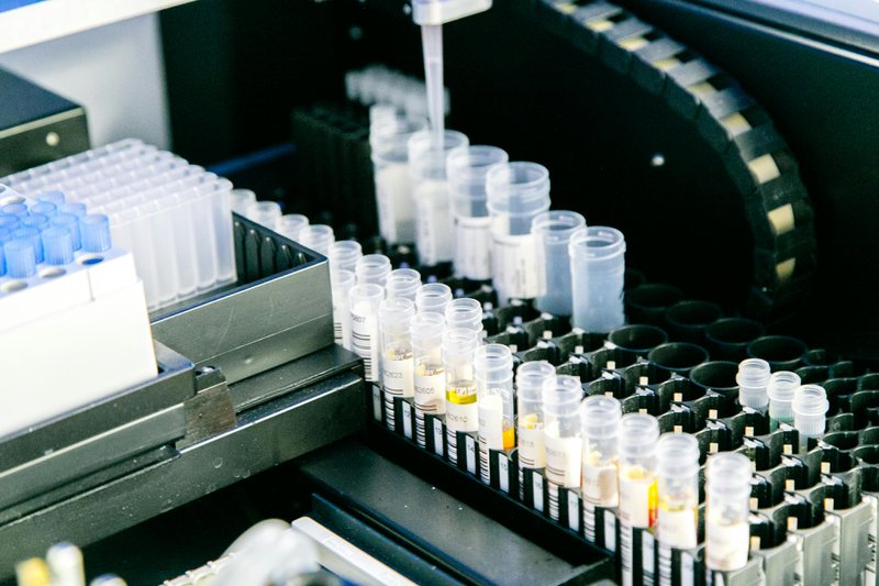 A photo of multiple vials in a reference laboratory office.