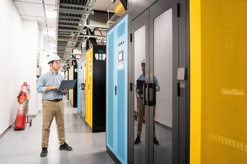 Specialized cleaning crew conducting zinc whisker remediation inside a data center using HEPA-filtered equipment and electrostatic-safe procedures.