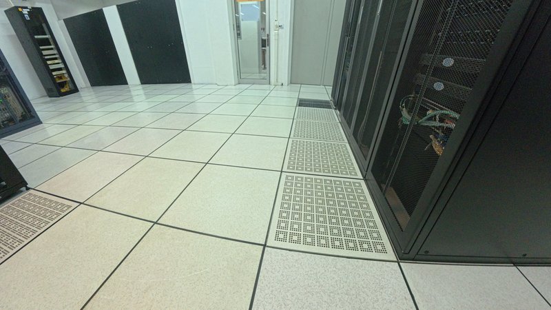 vented tiles in front of a rack of servers