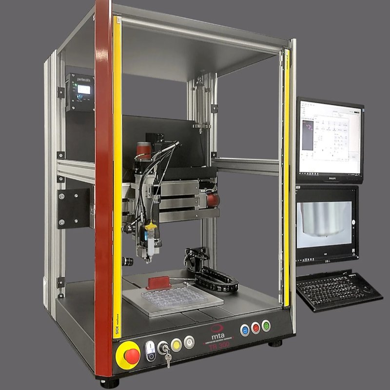 The image shows the T300 robot from mta robotics with the PDos X1 micro-dispensing jet valve. This is one of the few automated dispensing systems that can handle cyanoacrylate.