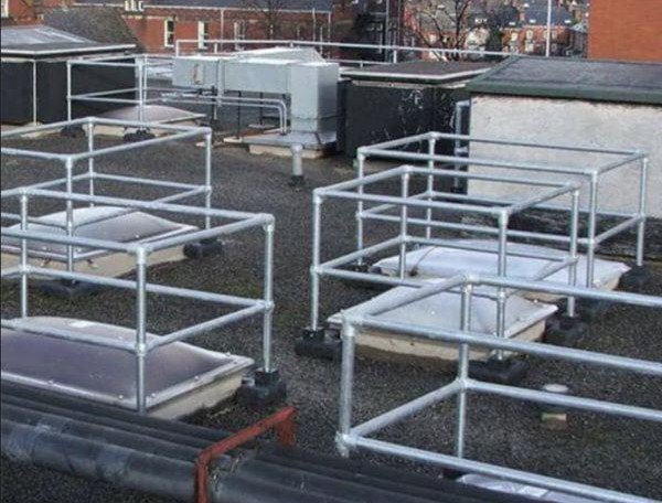 The image shows several rooftop safety barriers around skylights.