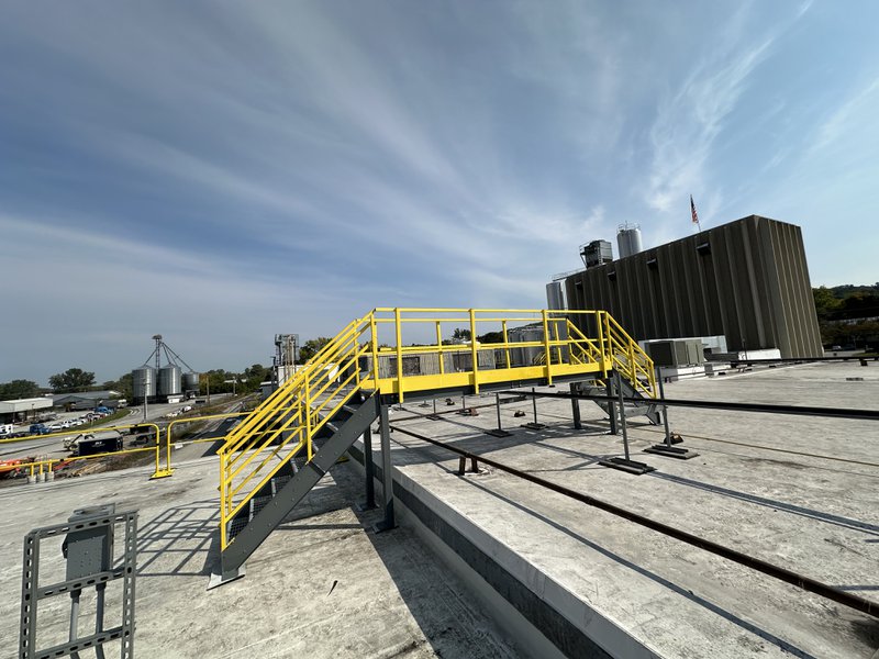 Yellow, metal, NextGen Crossover Stairway on a rooftop.