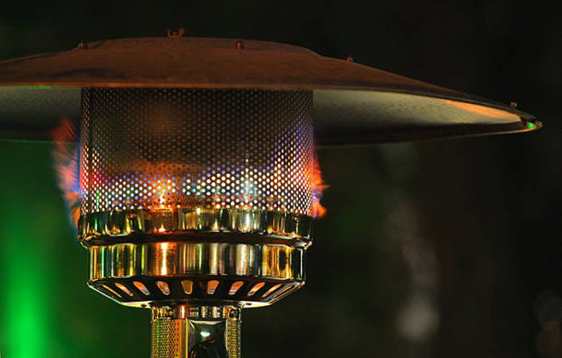 Close-up of a gas patio heater flame used for outdoor dining
