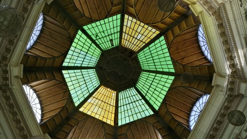 A detailed architectural stained glass ceiling inside a basilica evaluating Church Heating options.
