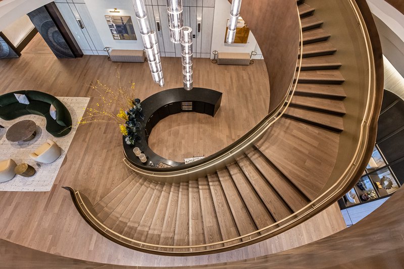 The image shows a grand spiral staircase.