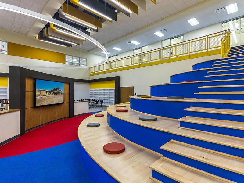 This photo features a school hall with natural maple stair treads