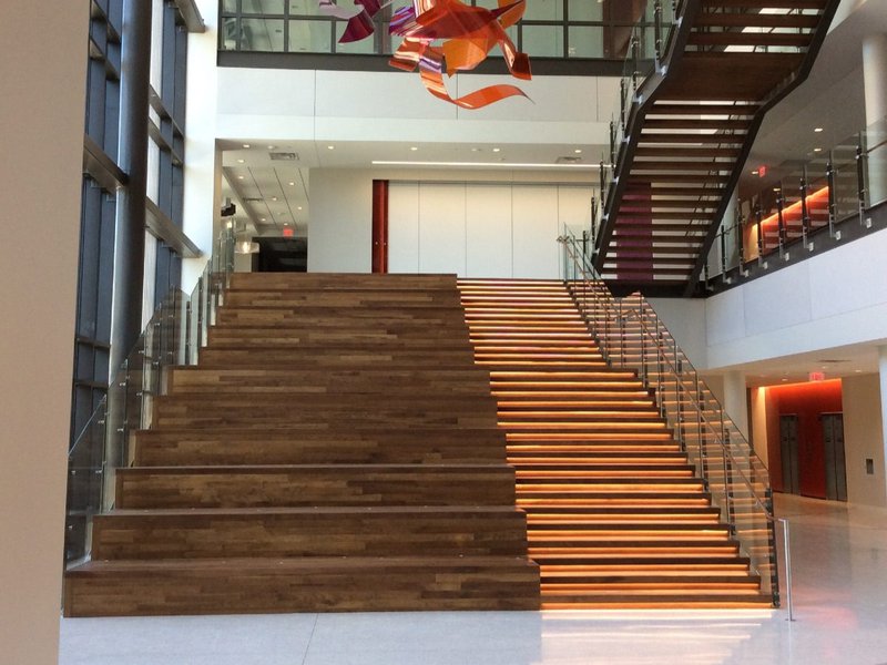 This photo features a staircase with integrated lighting and social seating