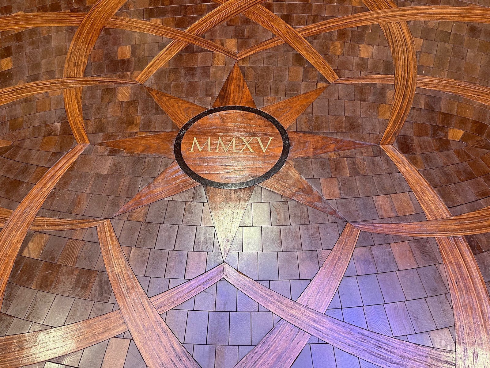 This photo features a bespoke wood flooring with a custom medallion This photo features a bespoke wood flooring with a custom medallion