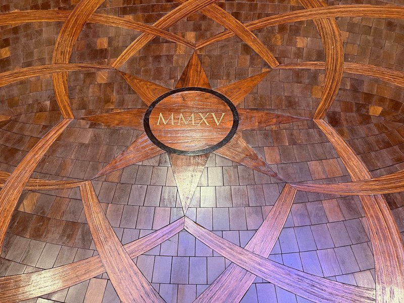 This photo features a bespoke wood flooring with a custom medallion