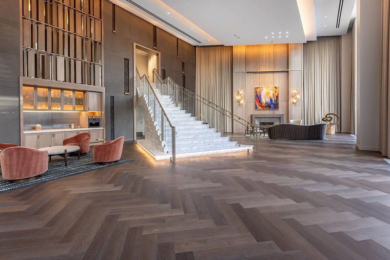 This photo shows how quality hardwood flooring can be used for cohesive transitions in spaces like hotel lobbies
