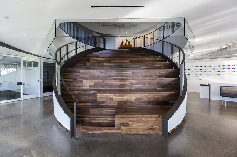 Walnut stair treads on a monumental staircase help provide a modern staircase design 