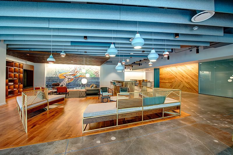 This photo features a common area that uses hickory flooring to create the illusion of a separated space