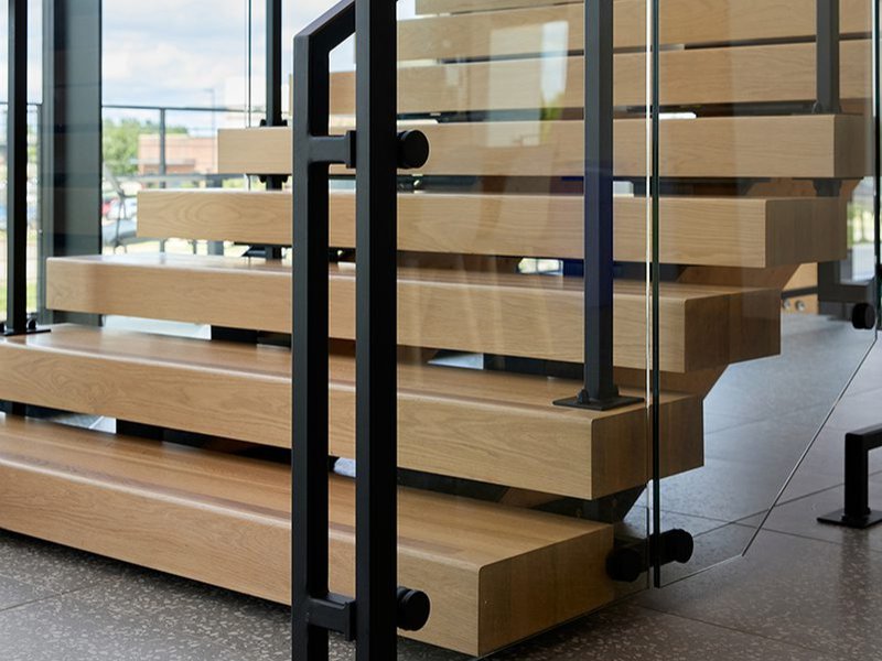 A stairway that prominently showcases Woodwright's 5' thick custom edge grain White Oak wood stair treads.