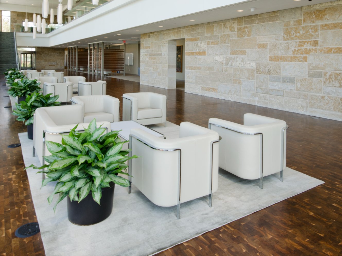 This photo showcases a lounge that uses hardwood flooring for a premium look