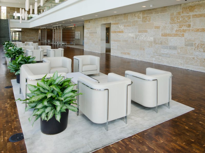 This photo showcases a lounge that uses hardwood flooring for a premium look