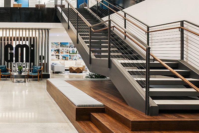 This photo features a statement staircase with integrated seating made out of hickory