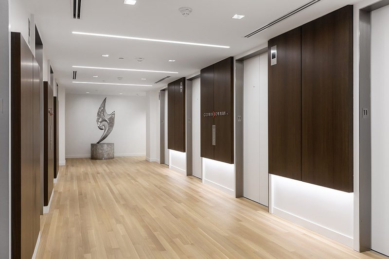 This photo features oak hardwood flooring in an elevator bank