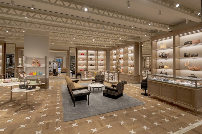Bespoke white oak wood flooring with marble inlay at a retail store