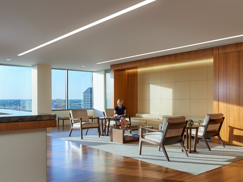 This photo features an office lobby with engineered wood floors that come with matching wall planks