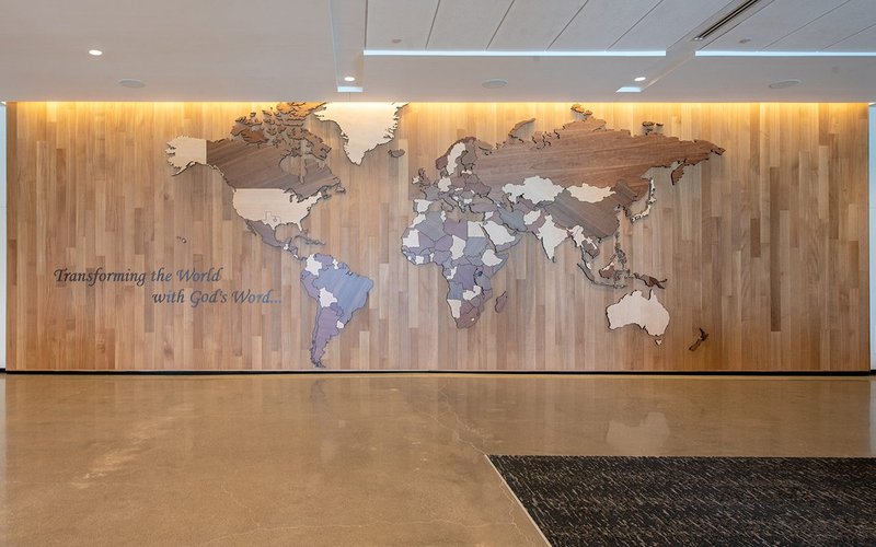 The image shows a CNC Cut Wood Wall of a world map