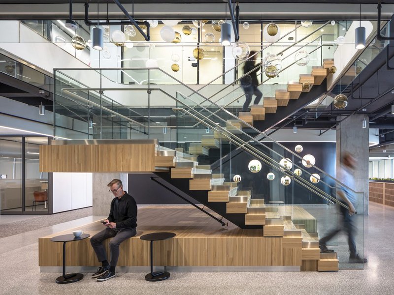 The image shows how contemporary style engineered floor planks and custom fabricated treads come together