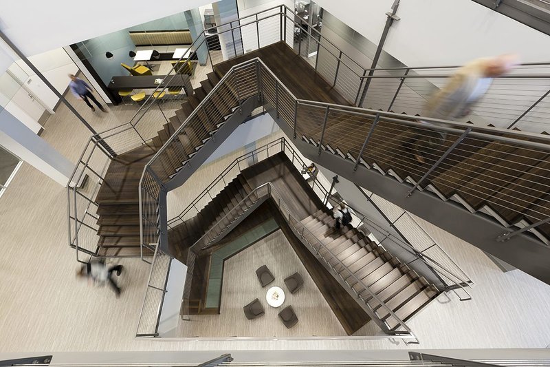 Massive office staircase that uses solid White Oak treads