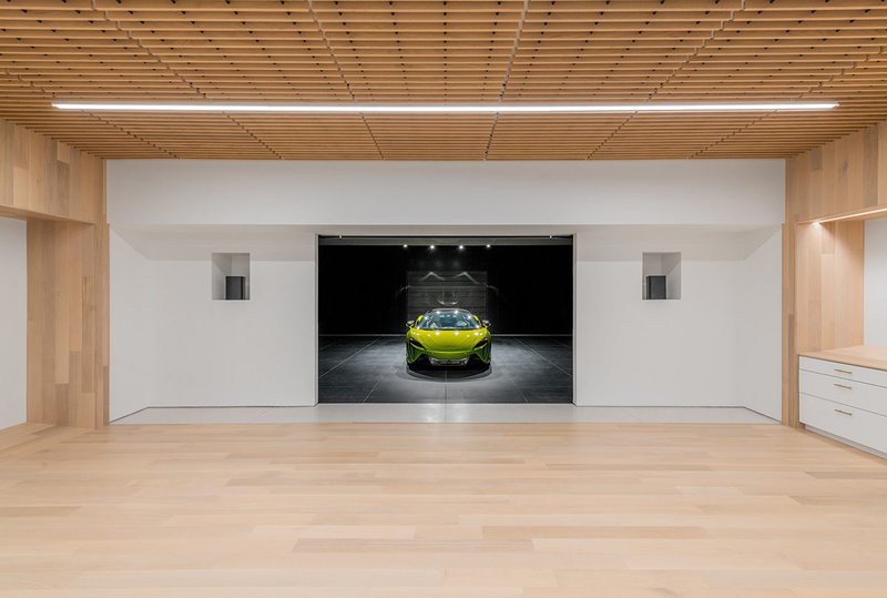 This photo features a car showroom that uses a Clear/Prime Hardwood Flooring Grade