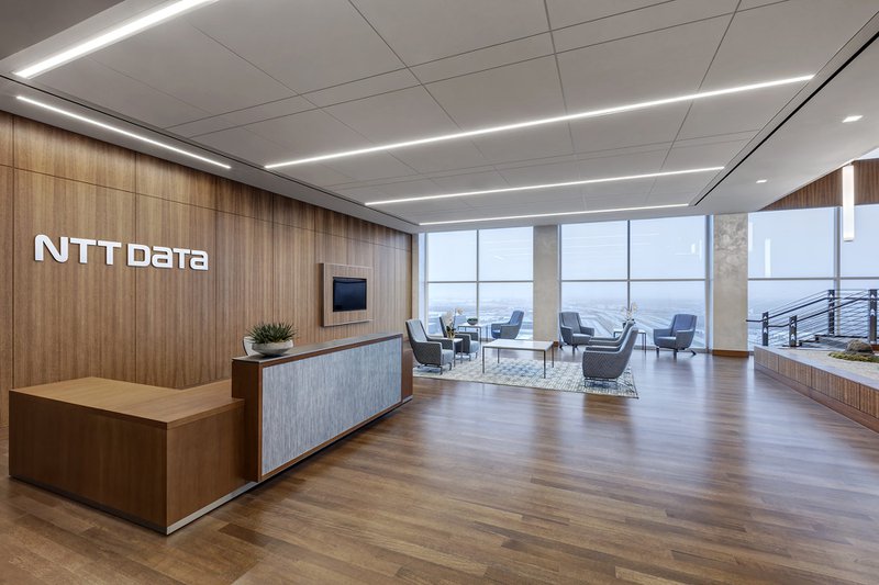 This photo features a corporate reception desk with hardwood flooring