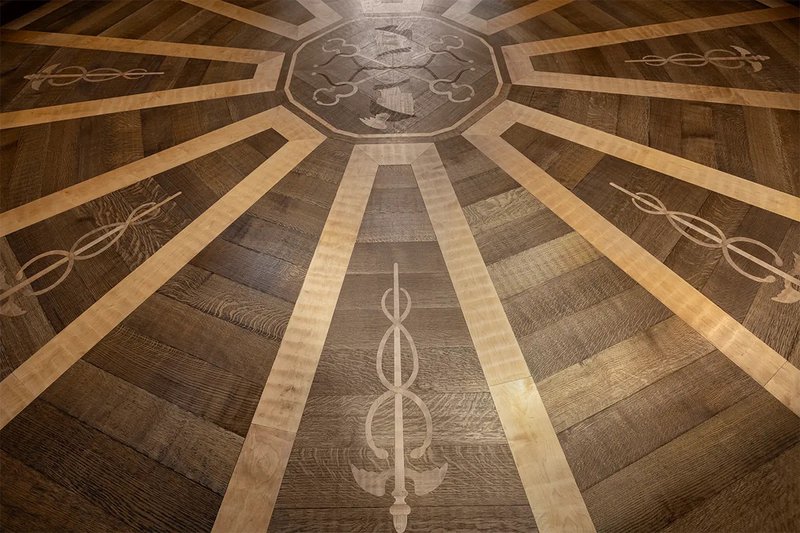 The image shows White Oak Flooring with Maple inlays installed by Woodwright. 
