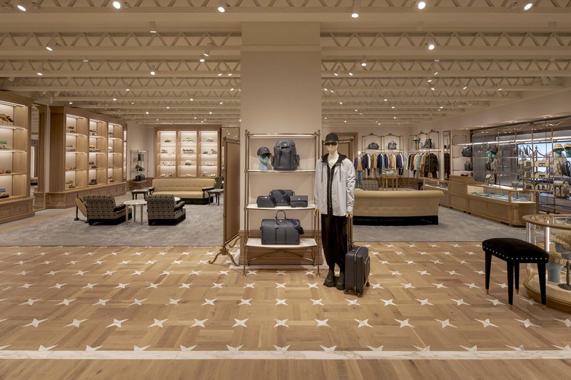 This photo showcases a retail store with white oak wood flooring with a customized design