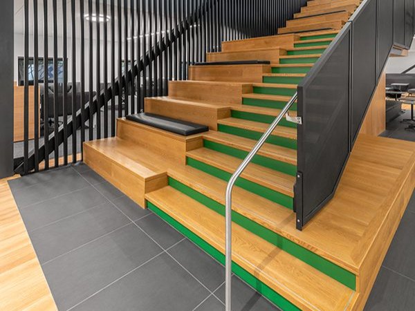 This photo showcases bespoke stairs using white oak and colored wood