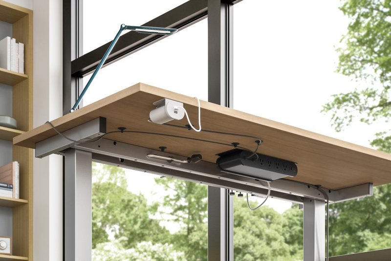 This photo features cord management tool installed under the desk