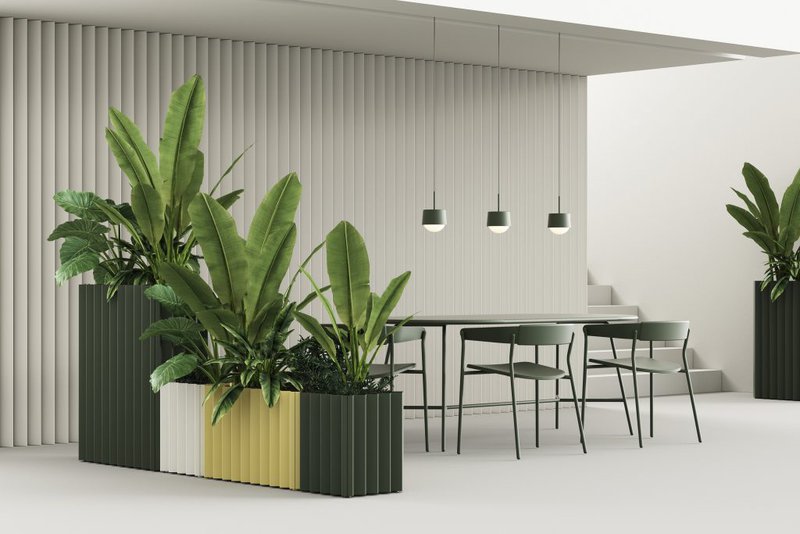 The image shows a few planters beside a large table