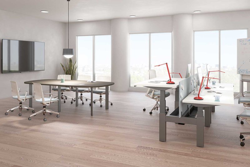 This photo features a collaborative workspace that uses double arm desk lights as the primary workstation lighting to keep the space tidy and organized.