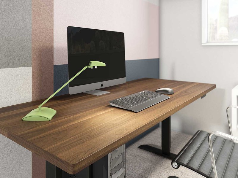 The image shows a Tino Desk Light being used as a workstation lighting.