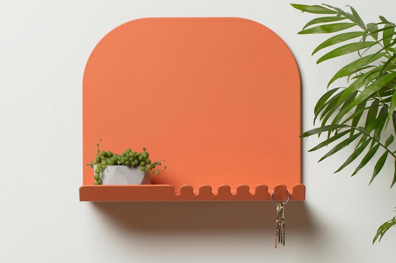 A wall shelf with a planter on top