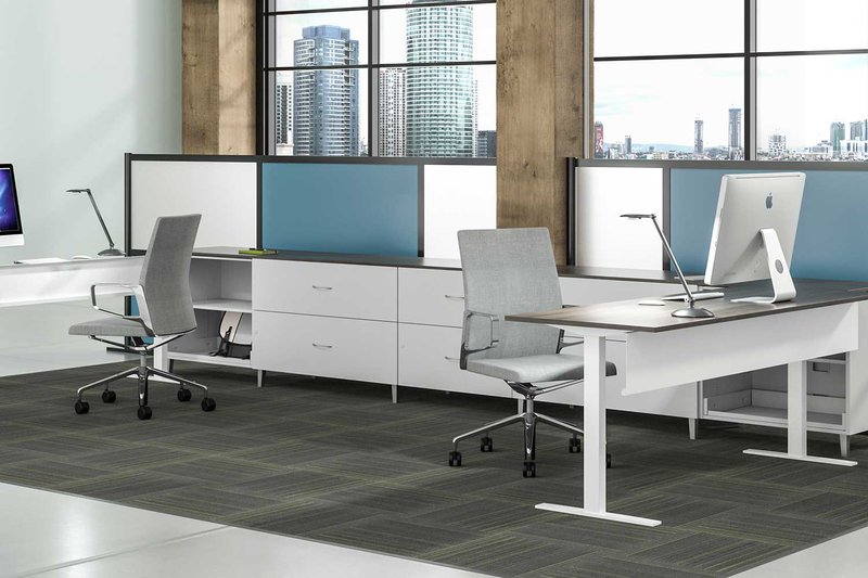 The image shows several white-colored chairs, desks, and workstations. A task lighting is shown on each table.