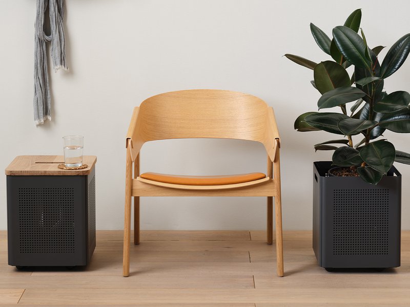 The image shows a Silas Storage Planter from Most Modest located right next to a chair.