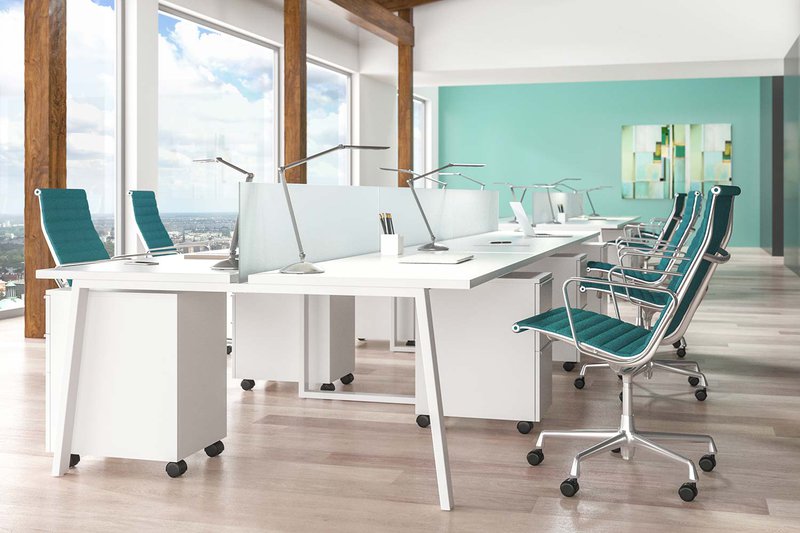 The image shows multiple double arm desk light from LightCorp being used to illuminate multiple workstations.