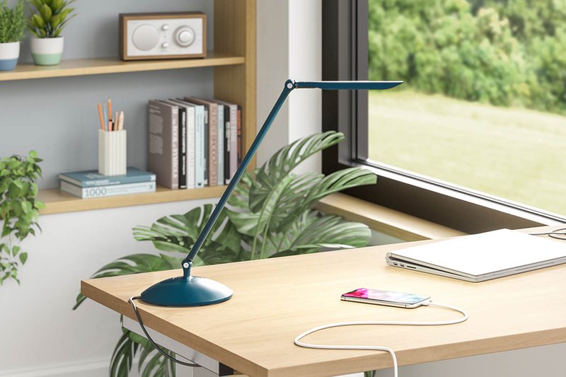 The image shows a task lighting positioned on top of a work station.
