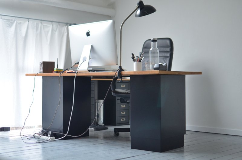 This photo features an executive desk with exposed cables
