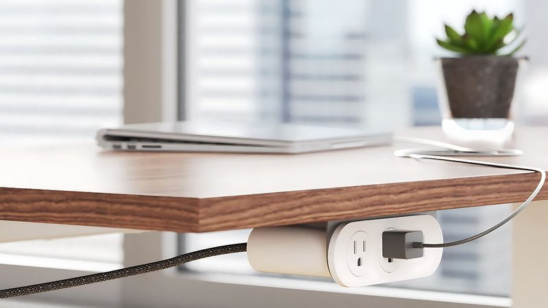 This photo features a charging station for an office desk: Nik