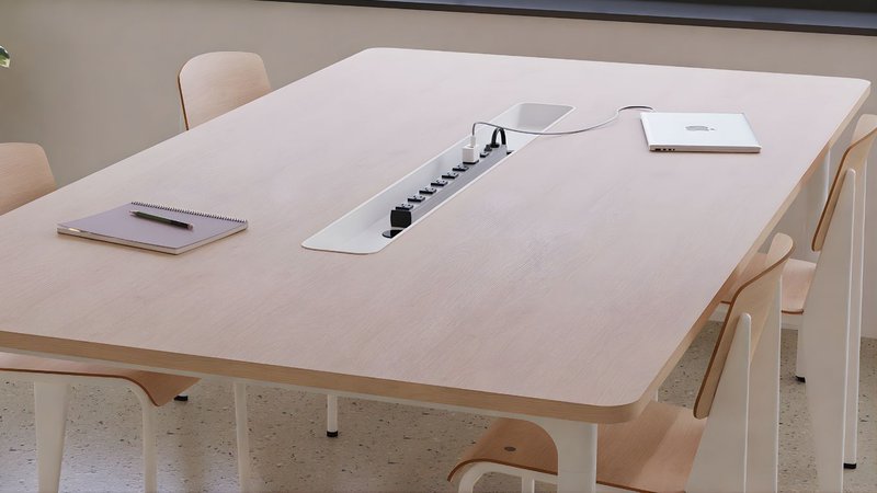 This photo showcases a recessed power strip in a wooden desk