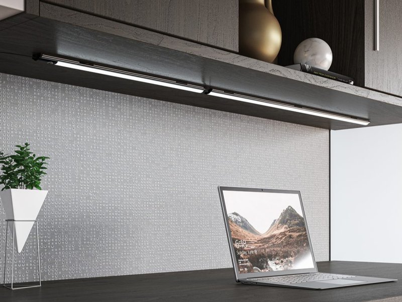 An overhead cabinet with an under shelf lighting