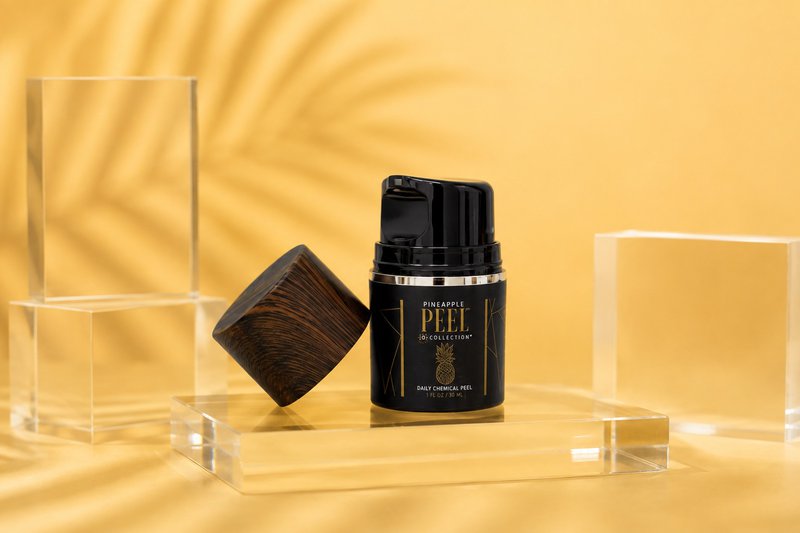 Pineapple peel for damage skin barrier displayed on clear acrylic blocks with a warm golden studio backdrop
