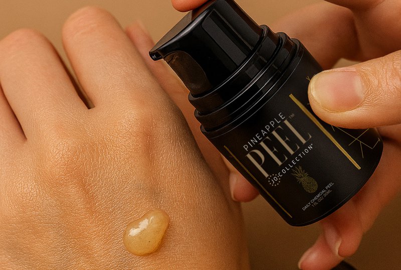 A hand with daily or monthly exfoliation with Pineapple Peel serum.