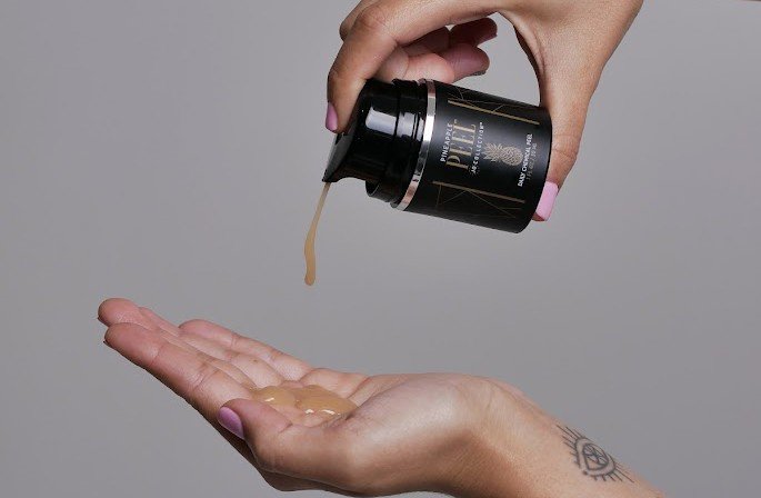 A hand with gentle pineapple peel to avoid over exfoliation