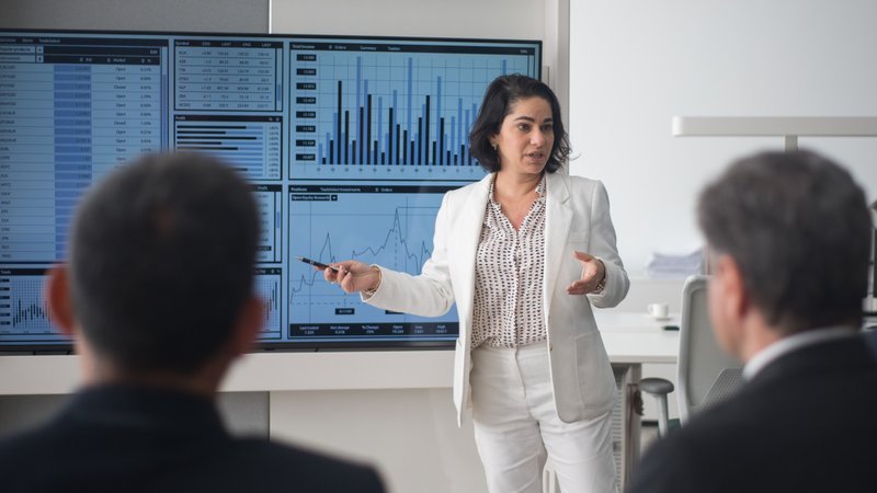 Project management team reviewing live field operations data to identify project margin risks